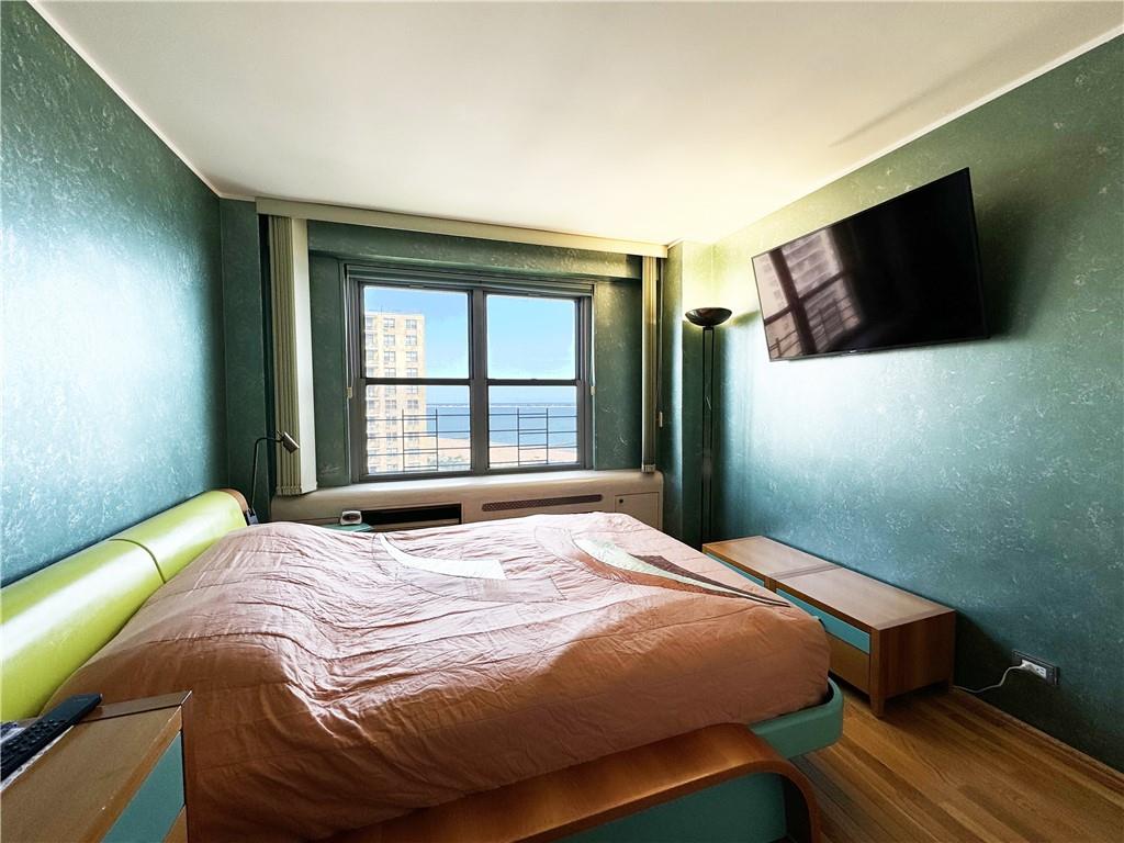 601 Surf Avenue, Unit 18E Brooklyn, NY 11224 - Photo 9 of 24 a bedroom with a bed and a flat screen tv