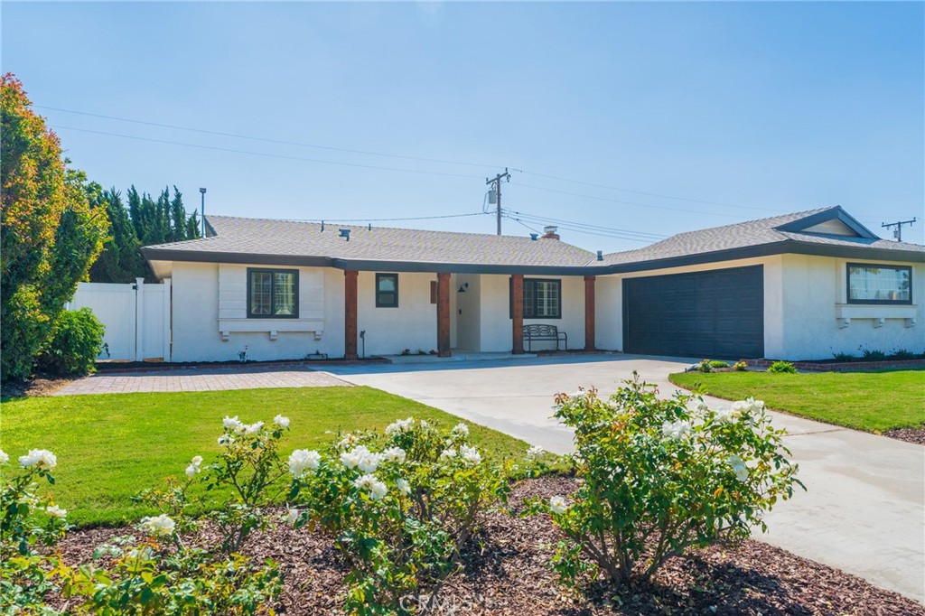 2436 East Tryon Avenue Anaheim, CA 92806 - Photo 1 of 1 a front view of a house with a yard and garage