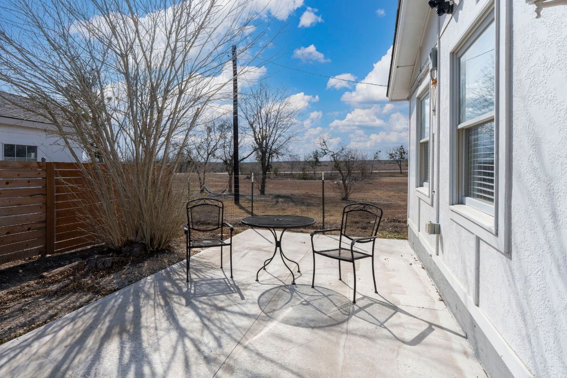 13415 Crane Road Buda, TX 78610 - Photo 14 of 22 Fenced backyard featuring a patio and outdoor dining area