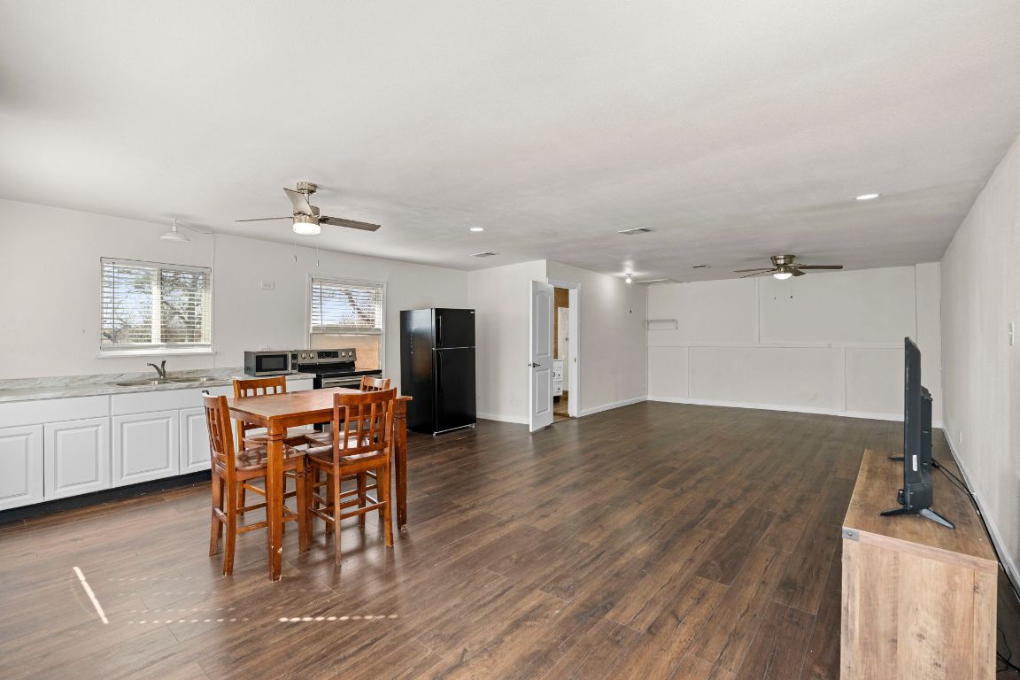 13415 Crane Road Buda, TX 78610 - Photo 15 of 22 Dining room with a ceiling fan and dark wood-style floors
