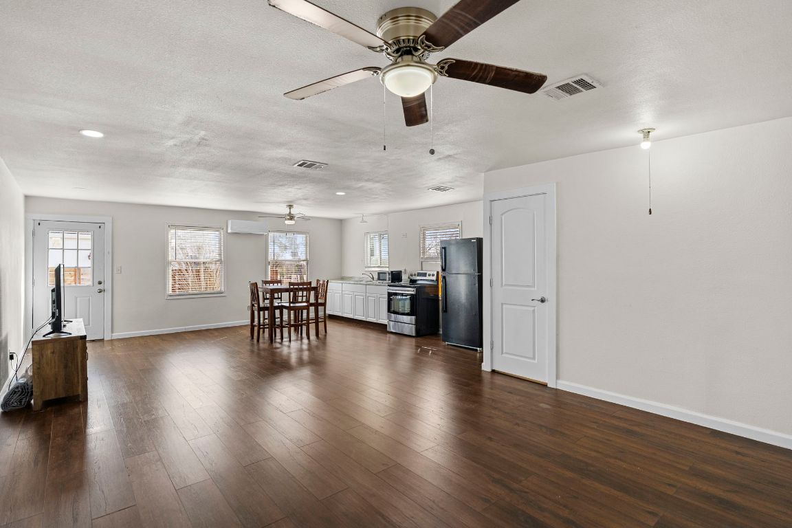 13415 Crane Road Buda, TX 78610 - Photo 20 of 22 Living area featuring dark wood-type flooring and a ceiling fan