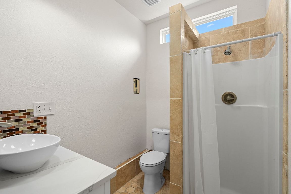 13415 Crane Road Buda, TX 78610 - Photo 7 of 22 Bathroom with a shower stall and vanity