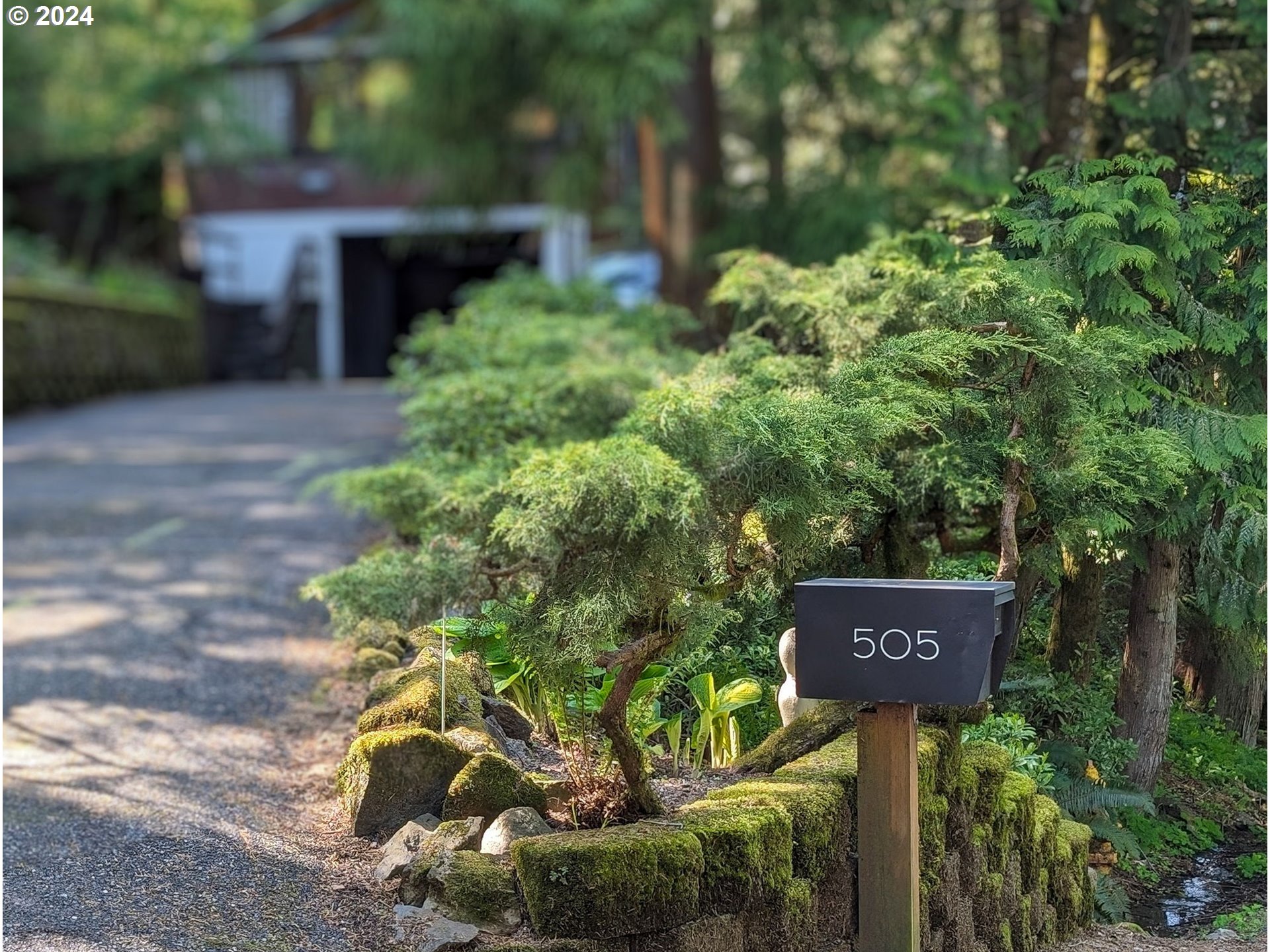 505 Northwest Greenleaf Road Portland, OR 97229 - Photo 3 of 44 a sign that is sitting in front of flowers