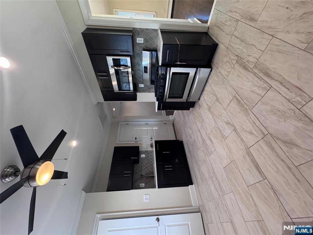 14 River Street Lodi, NJ 07644 - Photo 2 of 9 a large kitchen with stainless steel appliances granite countertop a stove and a sink