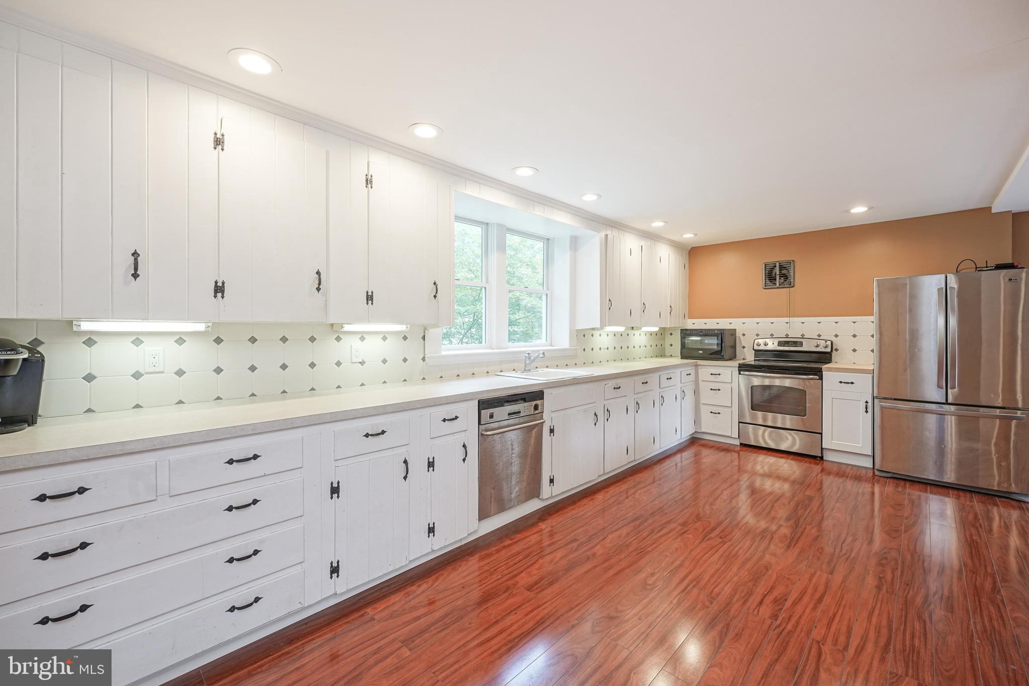 153 Hopewell Road Marlton, NJ 08053 - Photo 23 of 68 a kitchen with granite countertop white cabinets and white appliances