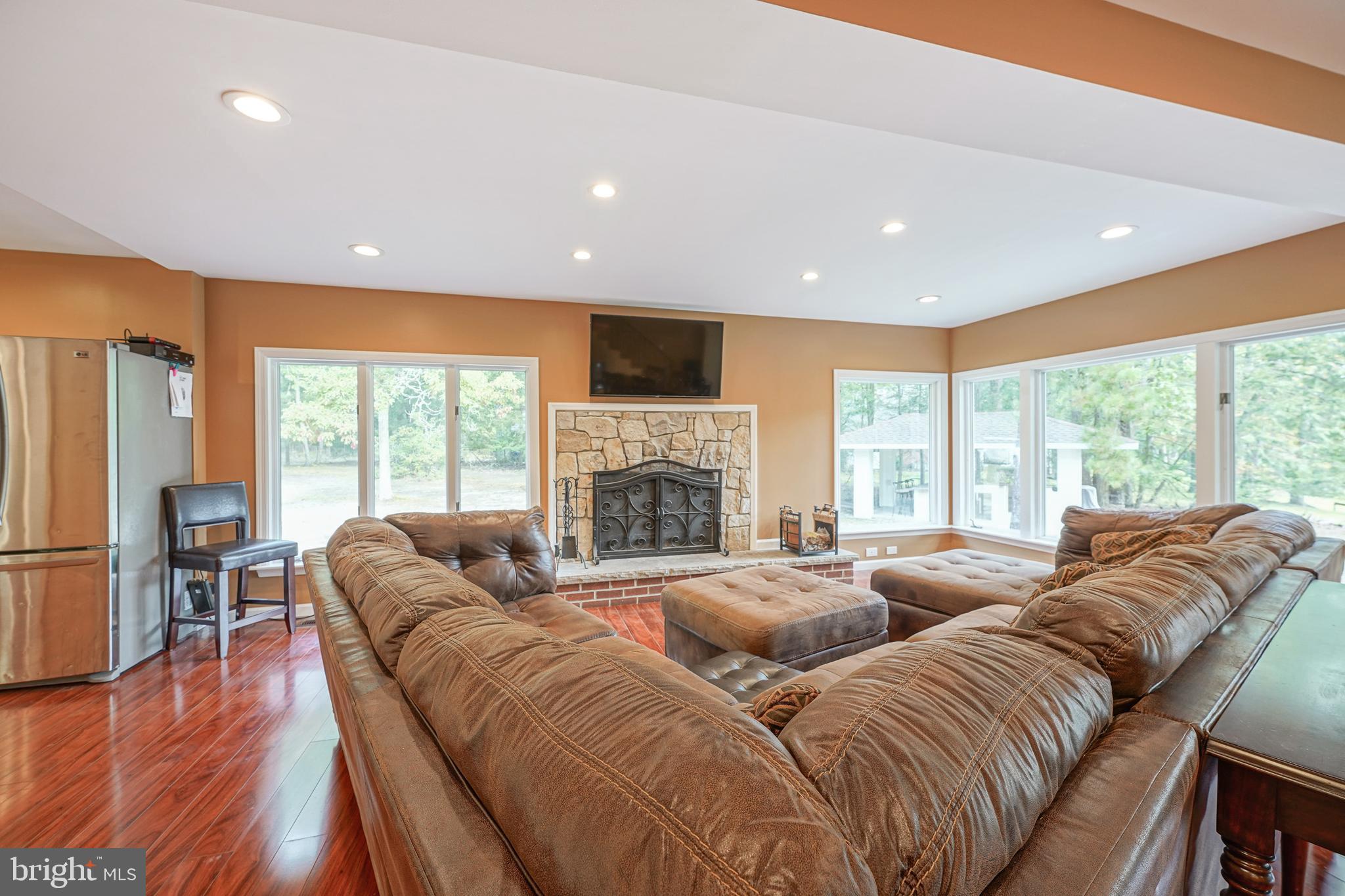 153 Hopewell Road Marlton, NJ 08053 - Photo 9 of 68 a living room with furniture flat screen tv and a fireplace