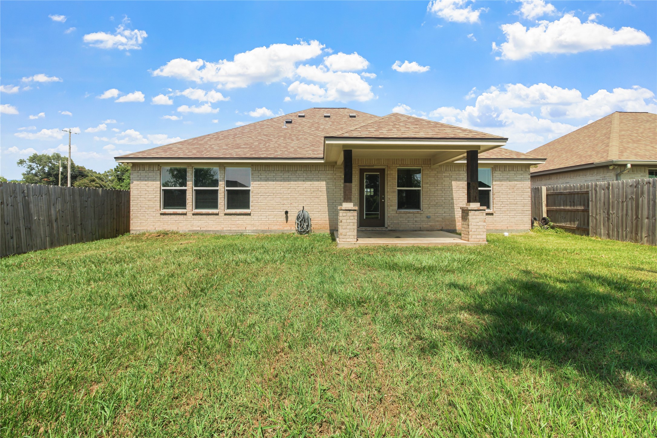 1208 East Henderson Road Angleton, TX 77515 - Photo 25 of 29 a view of a house with a yard and potted plants