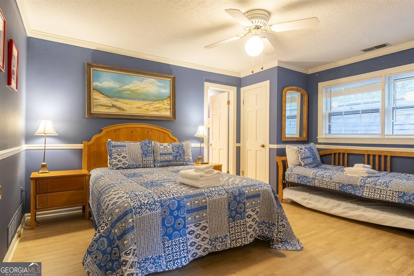 144 Fussen Strasse Helen, GA 30545 - Photo 23 of 38 a bedroom with a bed and a chandelier