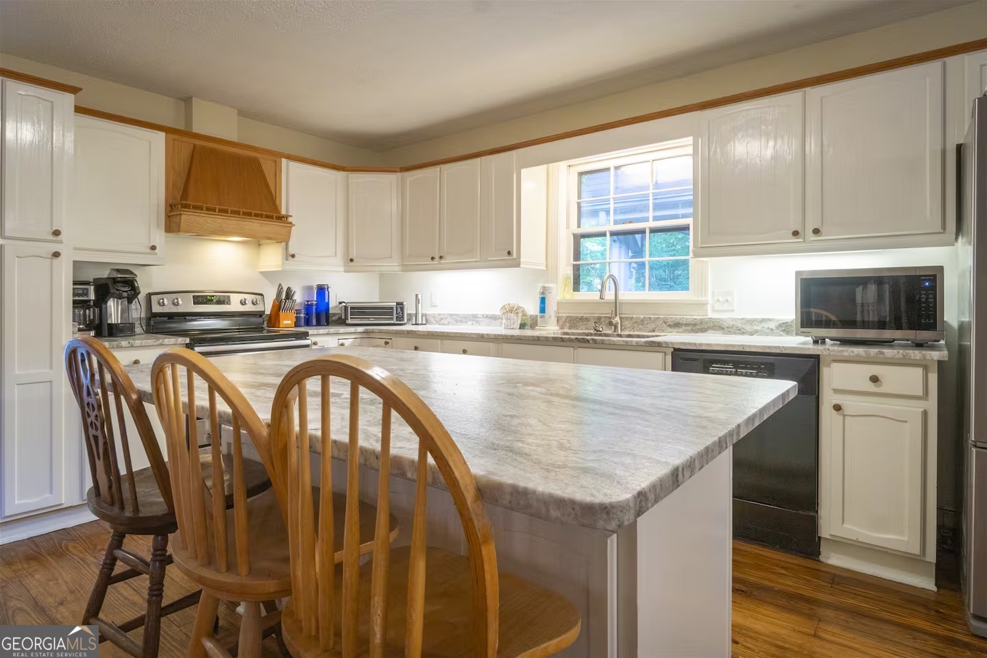 144 Fussen Strasse Helen, GA 30545 - Photo 26 of 38 a kitchen with stainless steel appliances granite countertop a stove a sink a microwave a refrigerator and cabinets