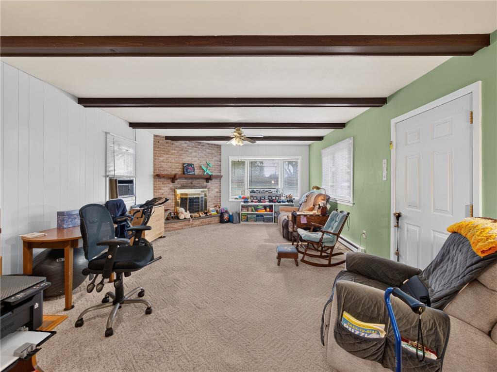 3046 Ridon Court Bethlehem, PA 18020 - Photo 20 of 41 A welcoming living space features exposed beam ceilings, a cozy brick fireplace, and ample natural light.