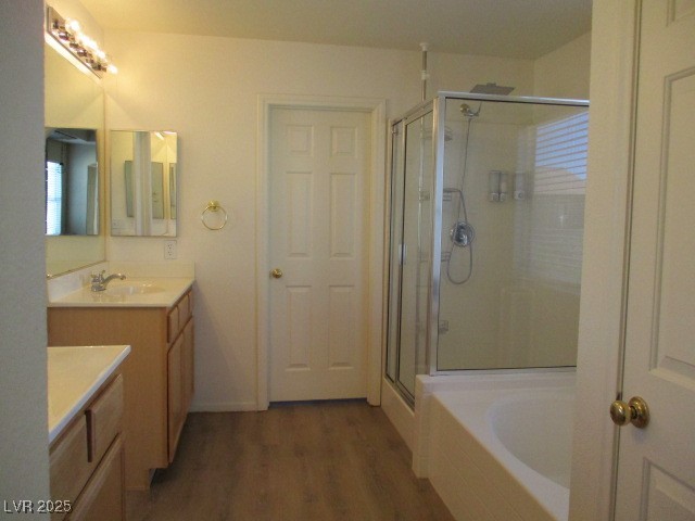 811 Wintersweet Road Henderson, NV 89015 - Photo 41 of 60 Full bath featuring a stall shower, dark wood finished floors, vanity, and a bath