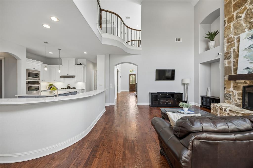 1011 Three Rivers Drive Prosper, TX 75078 - Photo 26 of 27 a living room with fireplace furniture and a wooden floor