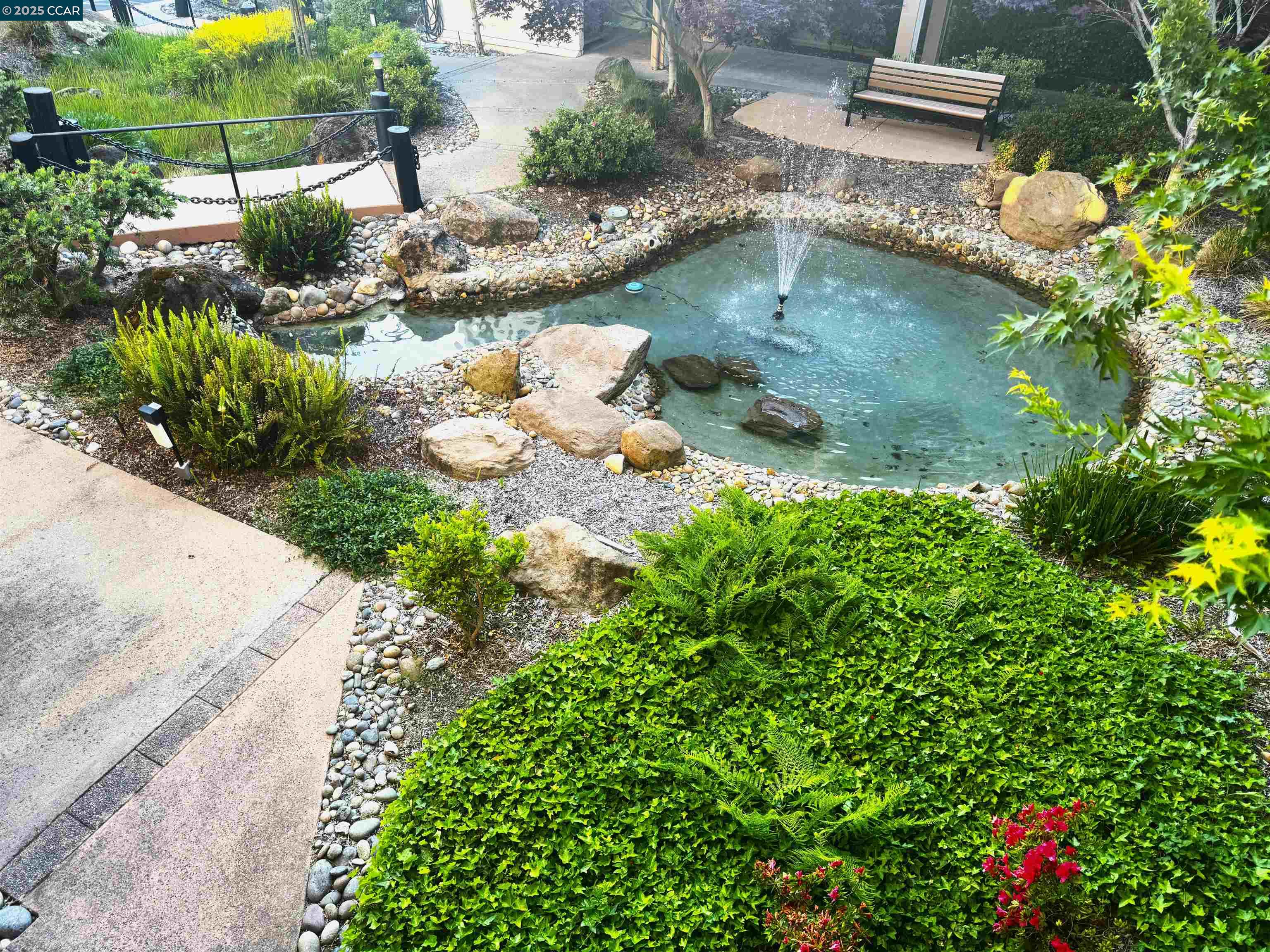 a backyard of a house with a yard and outdoor seating
