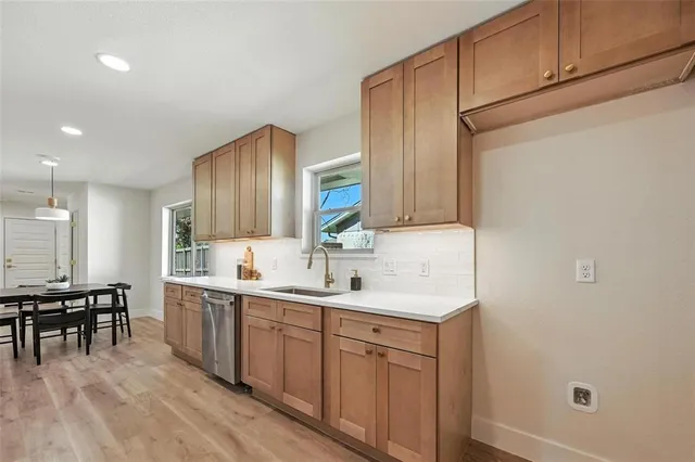 a kitchen with a sink cabinets and wooden floor