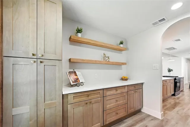 a kitchen with cabinets and window