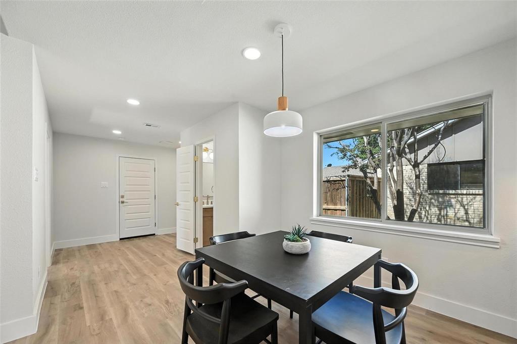 7620 La Risa Drive Dallas, TX 75248 - Photo 16 of 34 a view of a dining room with furniture window and wooden floor