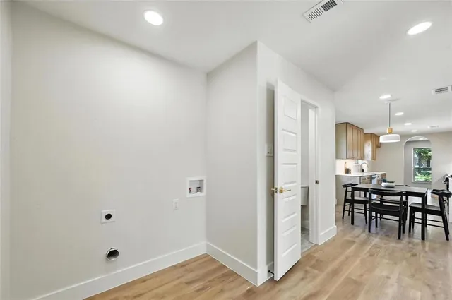 a view of a room with wooden floor and furniture