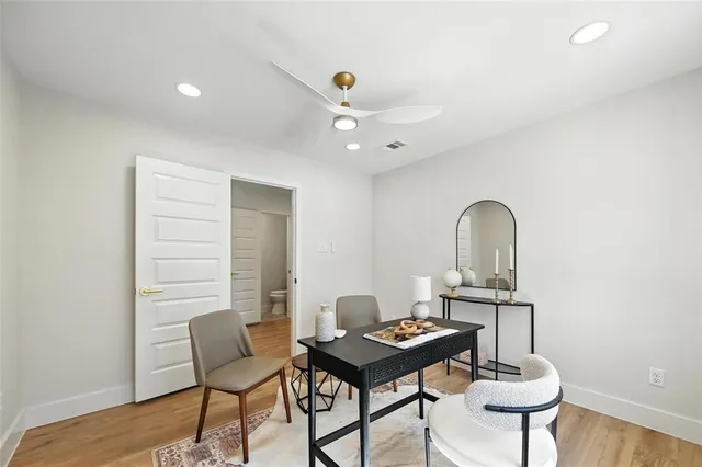 a living room with a table and chairs