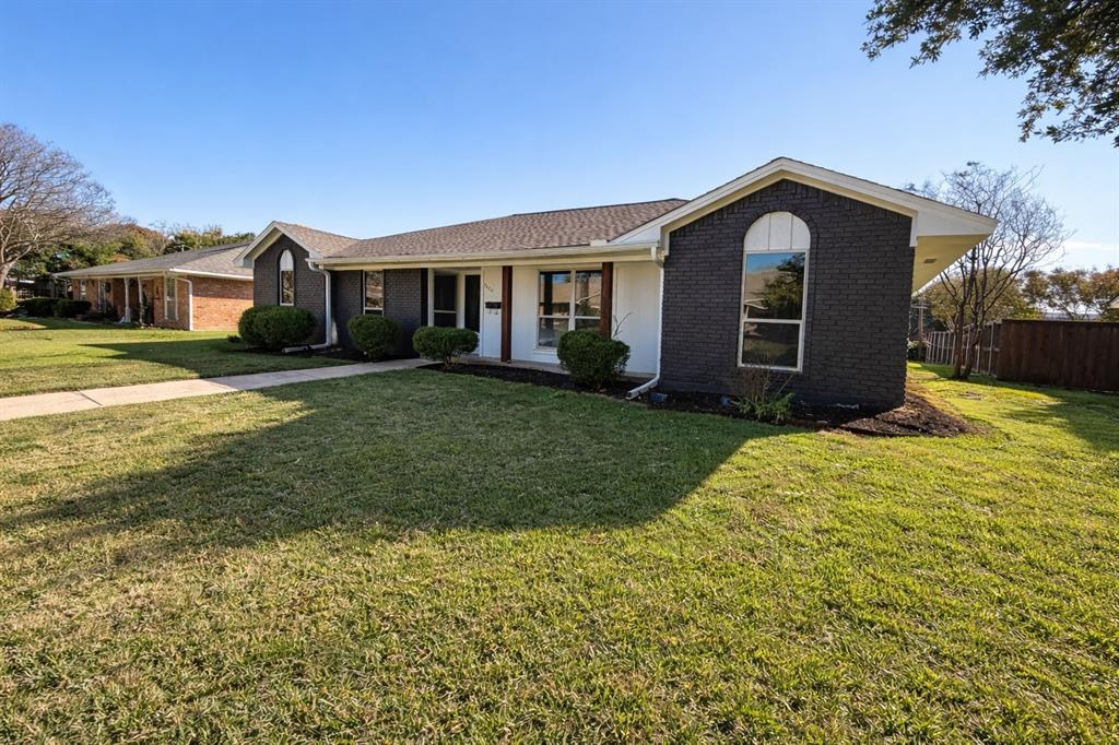 7620 La Risa Drive Dallas, TX 75248 - Photo 2 of 34 a front view of a house with a yard