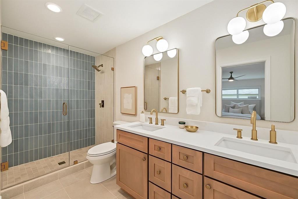 7620 La Risa Drive Dallas, TX 75248 - Photo 24 of 34 a bathroom with a double vanity sink mirror and toilet