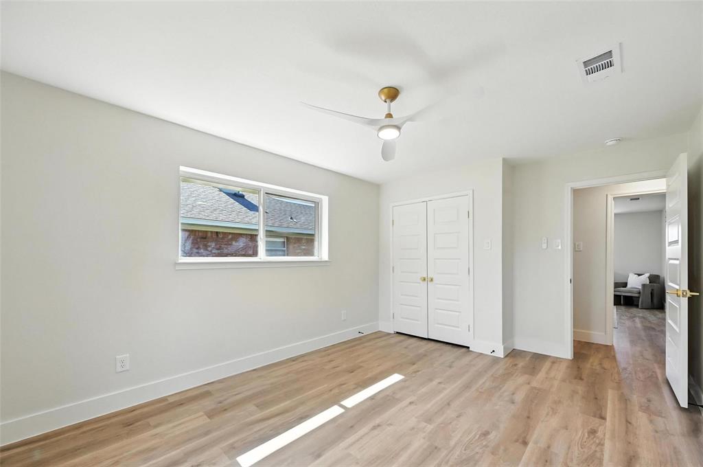 7620 La Risa Drive Dallas, TX 75248 - Photo 30 of 34 wooden floor in an empty room with a window