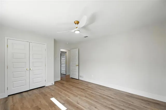 a view of an empty room with closet