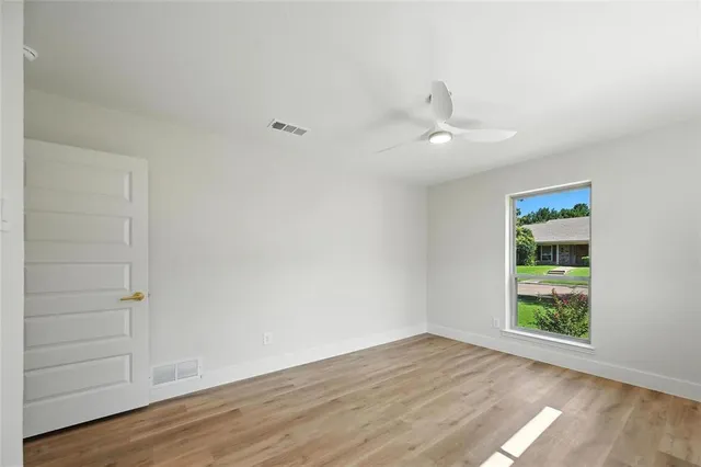 wooden floor in an empty room with a window