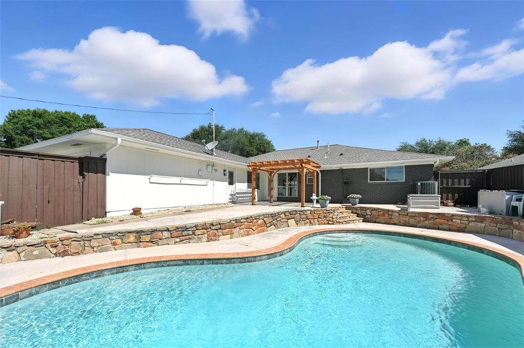 7620 La Risa Drive Dallas, TX 75248 - Photo 33 of 34 a front view of a house with swimming pool having outdoor seating