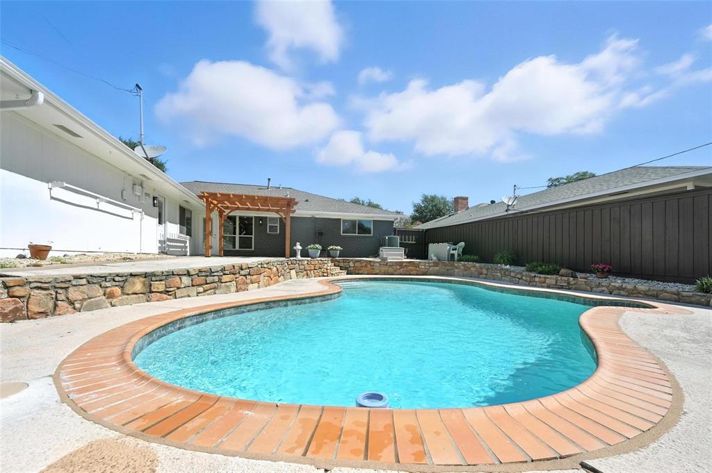 7620 La Risa Drive Dallas, TX 75248 - Photo 34 of 34 a view of a swimming pool with a outdoor seating