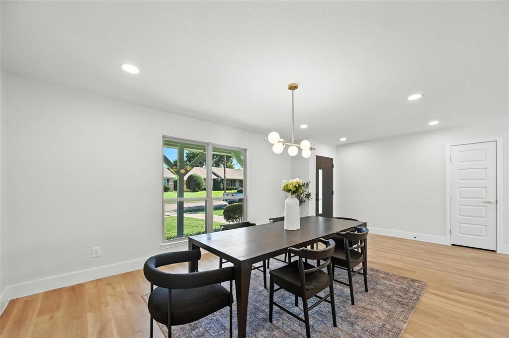7620 La Risa Drive Dallas, TX 75248 - Photo 4 of 34 a view of a dining room with furniture and wooden floor