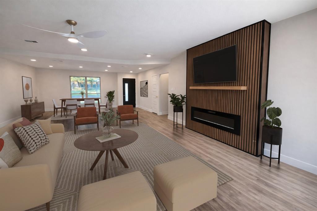 7620 La Risa Drive Dallas, TX 75248 - Photo 7 of 34 a living room with furniture a flat screen tv and kitchen view