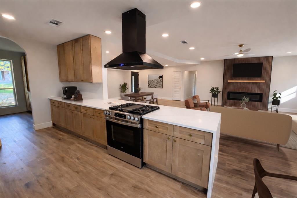 7620 La Risa Drive Dallas, TX 75248 - Photo 9 of 34 a kitchen with stainless steel appliances a stove a sink a microwave a refrigerator and cabinets