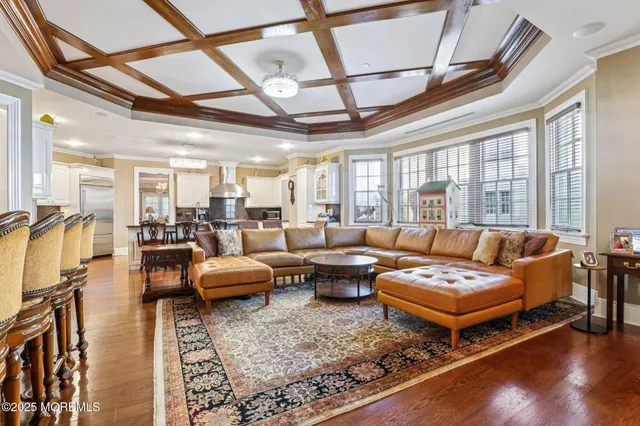 a living room with furniture and a chandelier