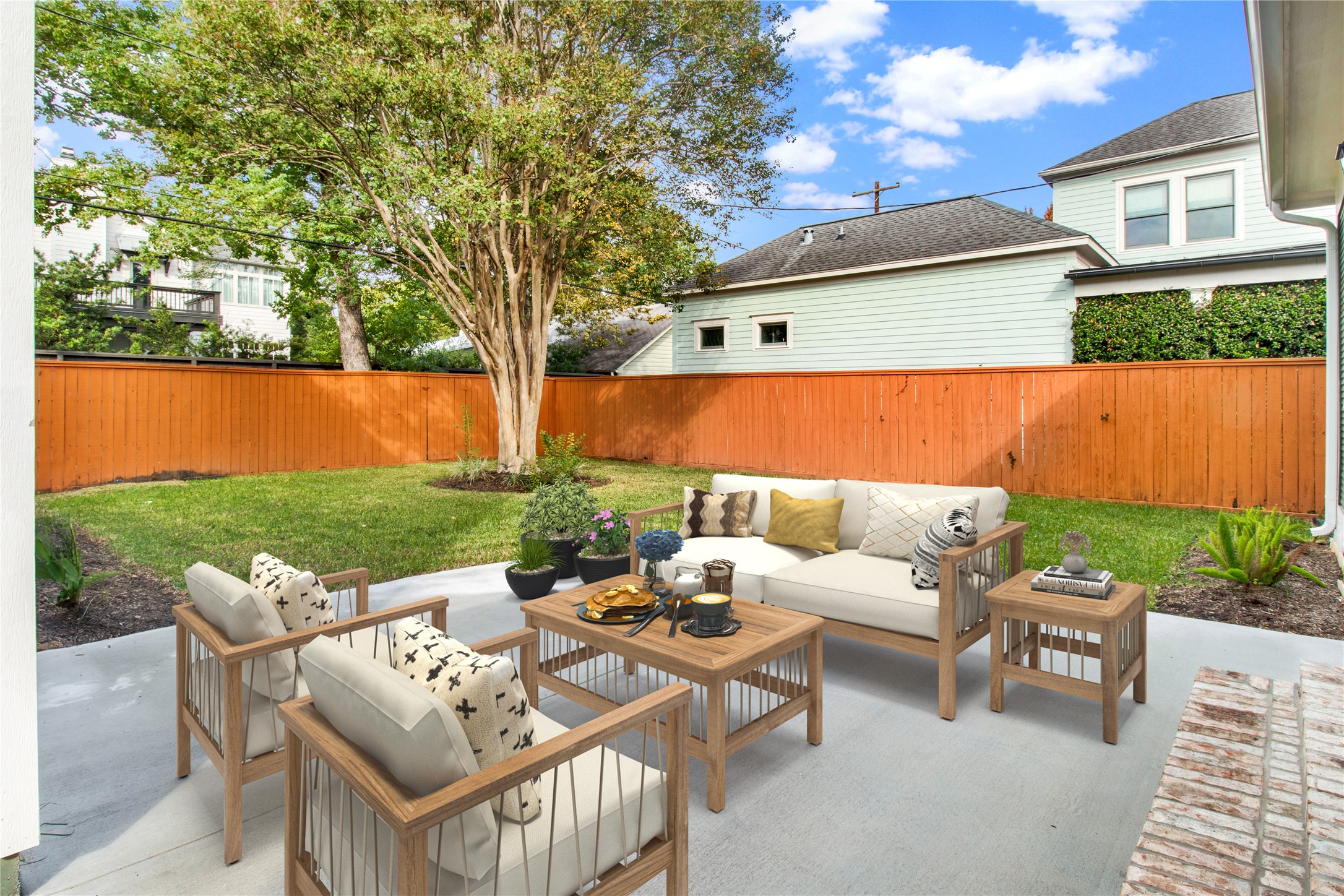 1535 Rutland Street Houston, TX 77008 - Photo 18 of 46 a view of a patio with couches table and chairs and potted plants