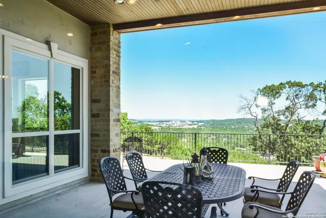 a kitchen with a stove a kitchen island a table and chairs in it
