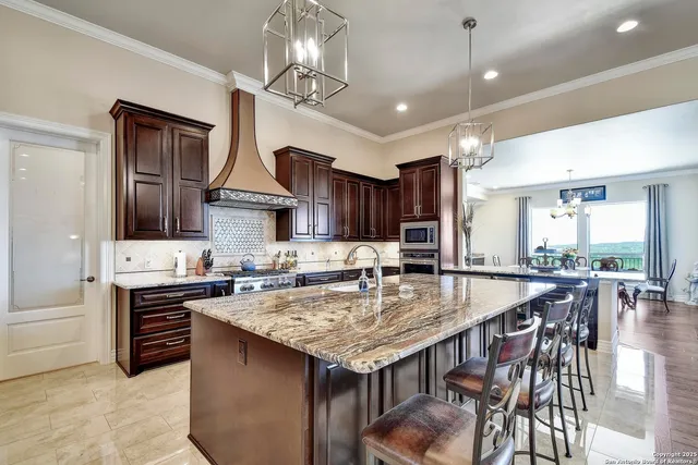 a view of kitchen with stainless steel appliances granite countertop a stove and a microwave
