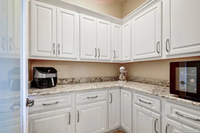 a view of a walk in closet with clothes and shoes