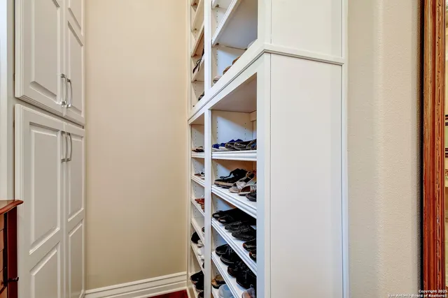 a en suite bathroom with a granite countertop sink and a mirror