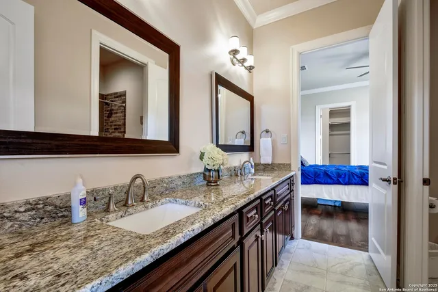 a view of a patio with table and chairs potted plants and floor to ceiling window