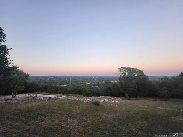 a view of a white house with a yard