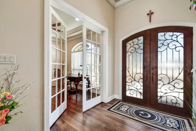 a living room with furniture and a view of kitchen