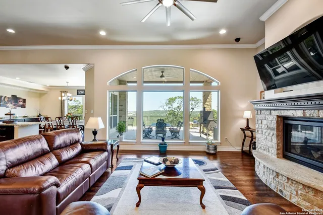 a living room with furniture a flat screen tv and a fireplace