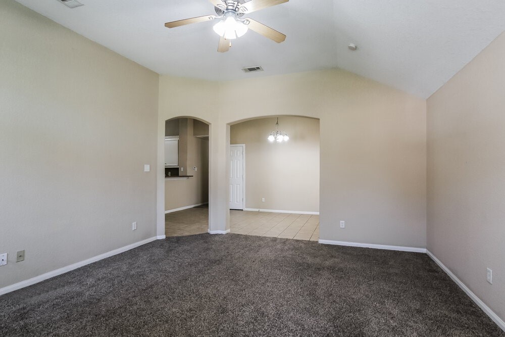 131 Golfview Court Conroe, TX 77356 - Photo 3 of 16 an empty room with chandelier fan