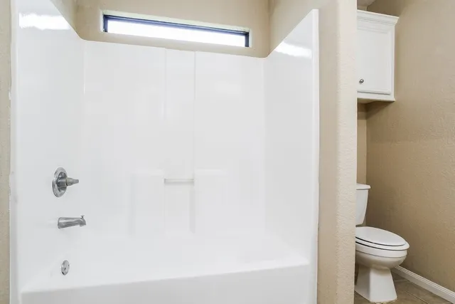 a bathroom with a toilet and a bathtub