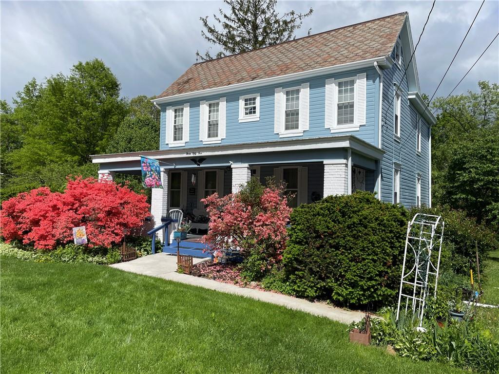 355 Old Plank Road Butler, PA 16002 - Photo 2 of 36 a front view of house and yard with beautiful flowers and green space