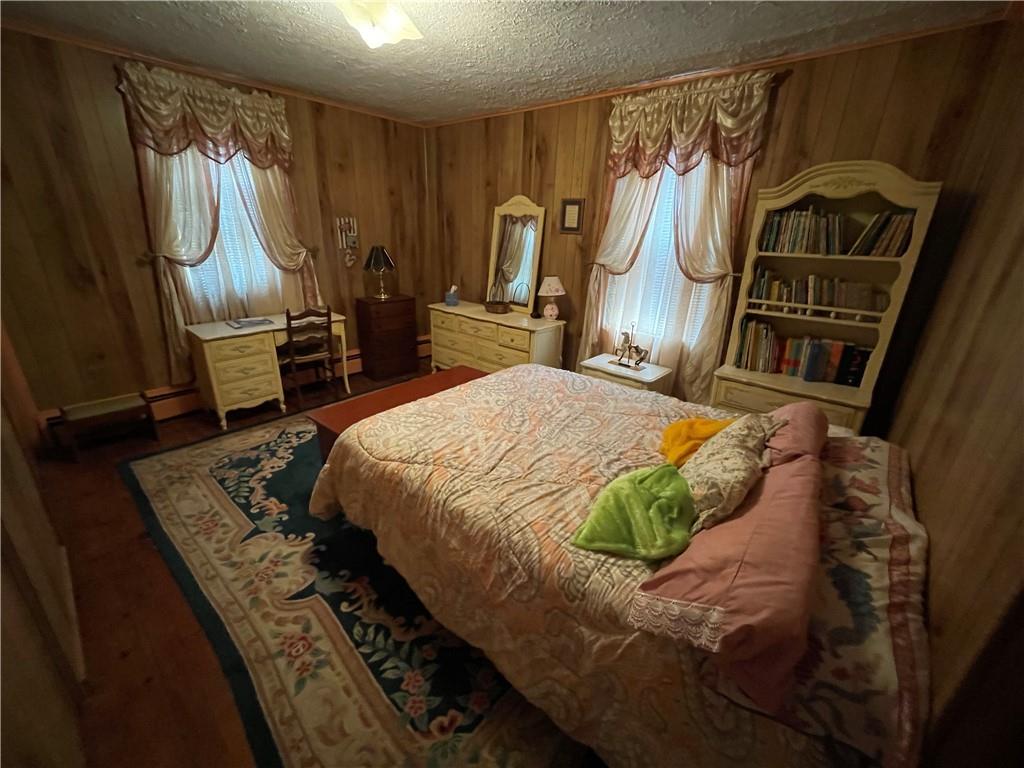 355 Old Plank Road Butler, PA 16002 - Photo 23 of 36 a bedroom with a bed a dresser with wooden floor