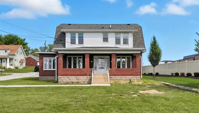 a front view of a house with a yard