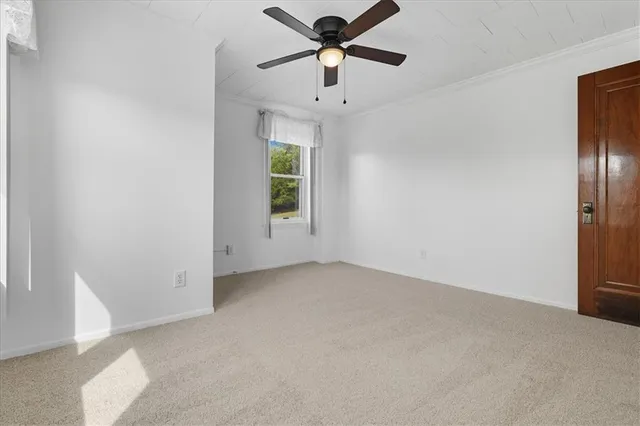 a view of a livingroom with a ceiling fan and window
