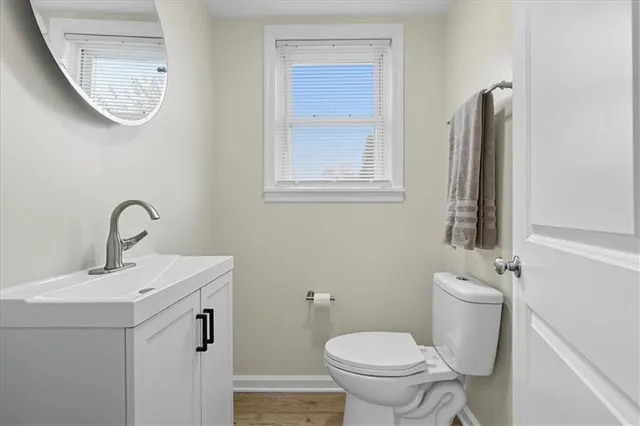 a bathroom with a sink mirror and toilet
