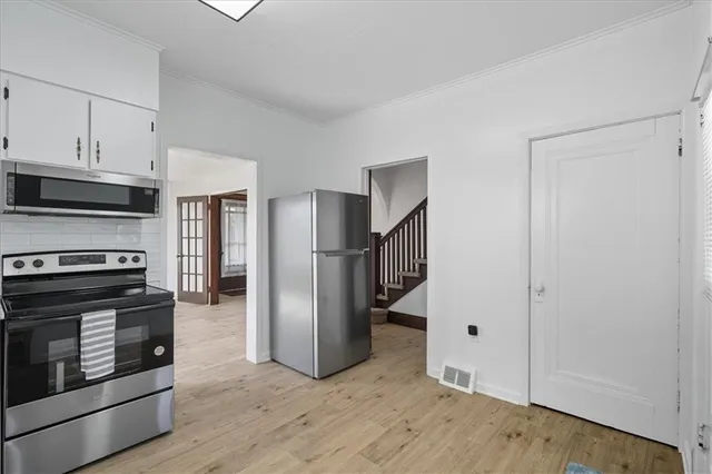 a kitchen with stainless steel appliances granite countertop a refrigerator and a stove top oven